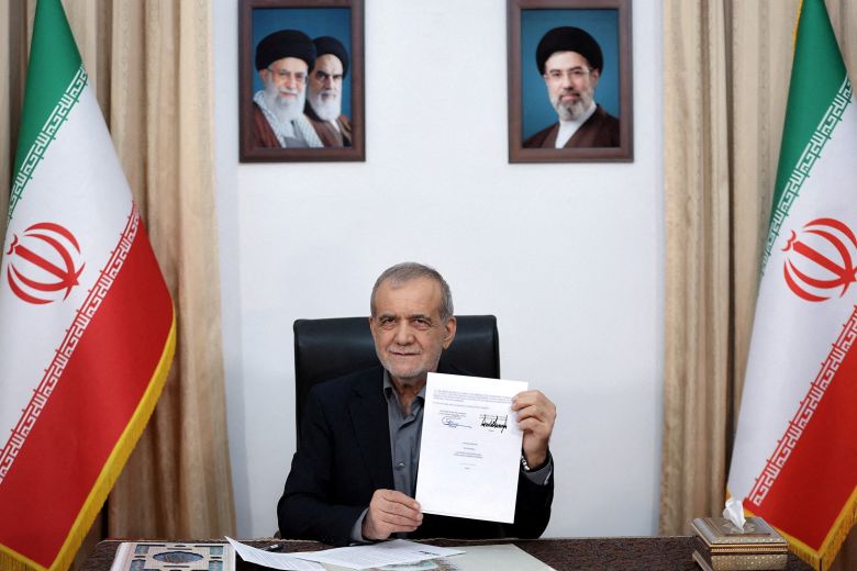 Iranian President Masoud Pezeshkian displays the US memorandum of understanding in Tehran on June 18, 2026.