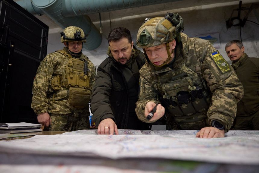 Zelensky listens to Oleksandr Syrskyi as he visits a position of Ukrainian servicemen in the town of Kupiansk on November 30, 2023.