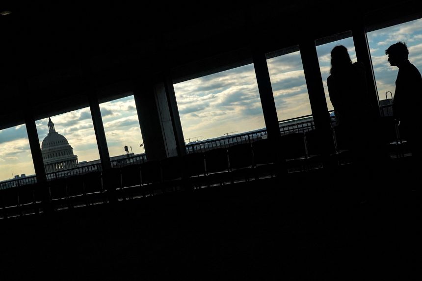 Staffers are seen near the US Capitol in Washington, DC, on February 12.