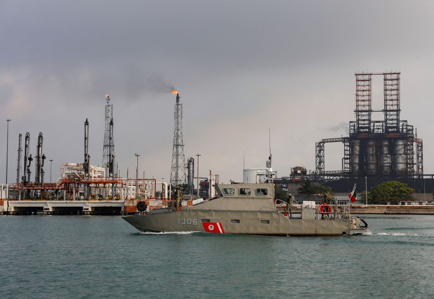 Members of the Mexican navy patrol in a boat next to a refinery of Mexican state oil company Pemex in Ciudad Madero, Mexico, on May 28, 2025.