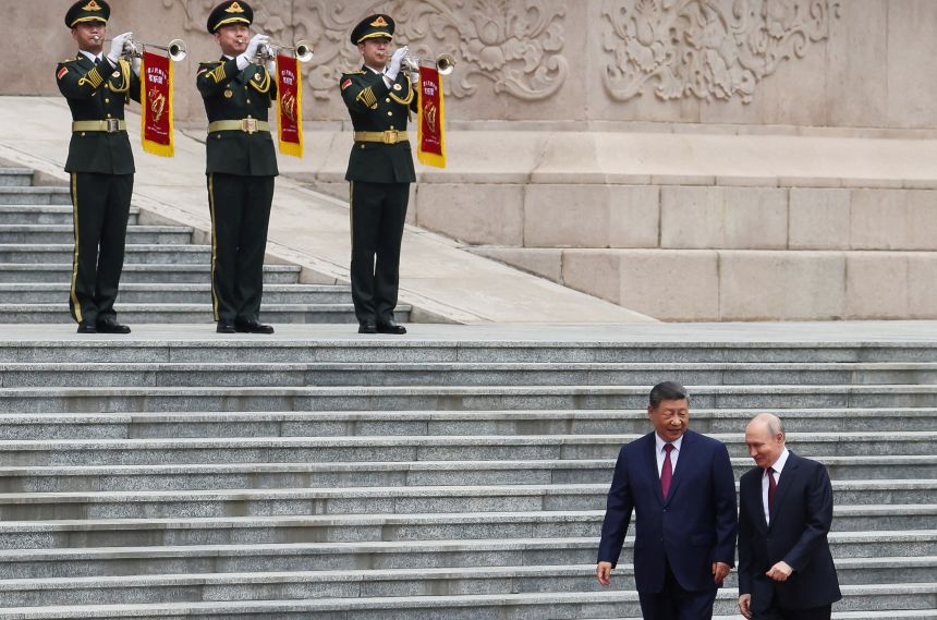 Russian President Vladimir Putin and Chinese President Xi Jinping attend a welcoming ceremony at the Great Hall of the People in Beijing, on May 20.