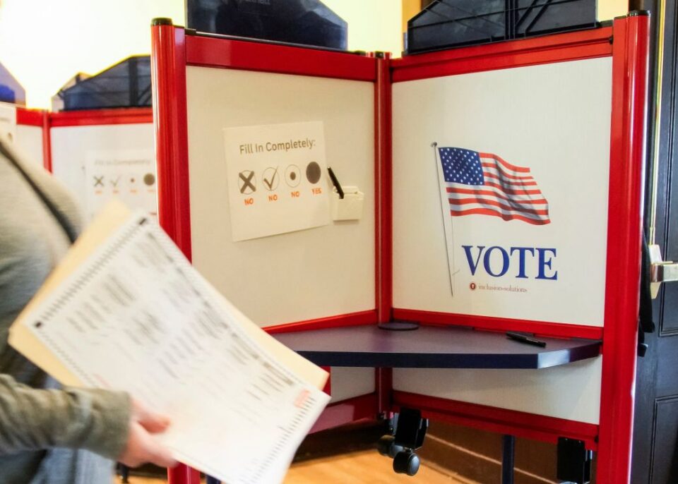 A person walks with her ballot to vote during the New Jersey primary elections, in Glen Ridge, New Jersey, on June 2.
