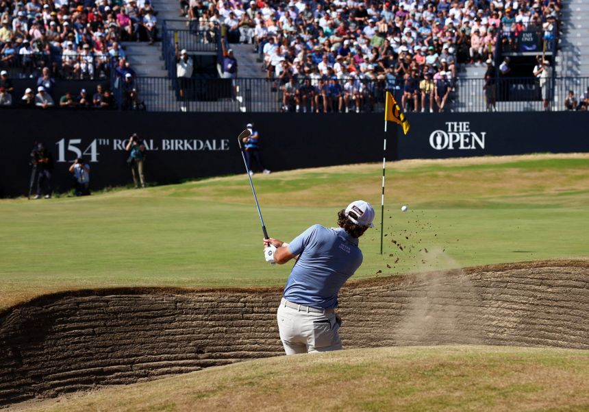 Cameron Young hits a ball out of the bunker in the 18th hole on Sunday.