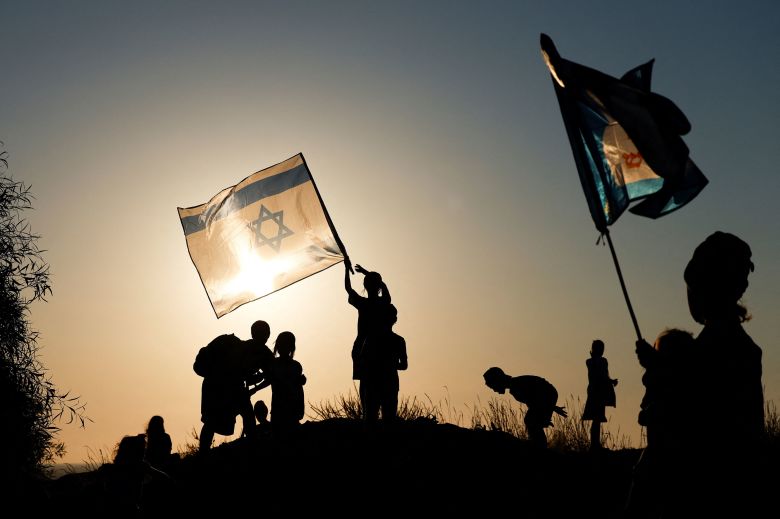 2026-07-19t181847z-44209871-rc25hma3bo2z-rtrmadp-3-israel-palestinians-gaza-march Pro-settlement Israelis march with flags towards the Gaza border in southern Israel on Sunday.