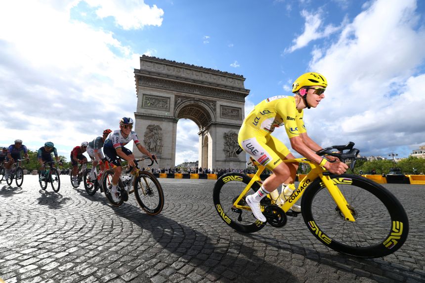 Pogacar with other cyclists as they ride past the Arc de Triomphe during stage 21 of the Tour de France on Sunday.