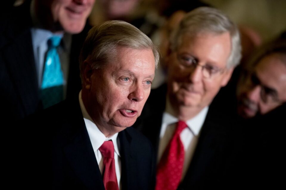 Sen. Lindsey Graham, flanked by then-Senate Majority Leader Mitch McConnell, right, speaks to reporters at the US Capitol on September 26, 2017.