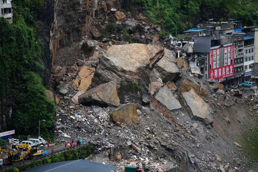 Rescuers stand by to conduct a search and rescue operation at the scene of a landslide in southwestern China's Chongqing city on July 18, 2026.