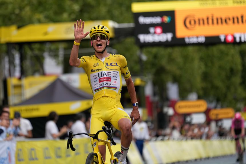 Slovenia's Tadej Pogacarcelebrates as he crosses the finish line on Sunday in Paris.