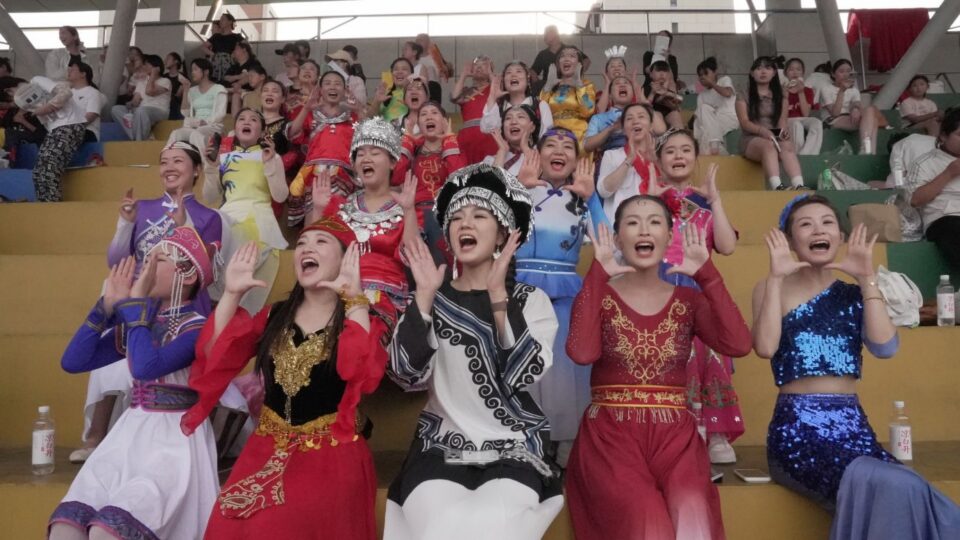 A group of local "cheerleaders" in Hebei province's Fuping county shout their support for players during a Village Super League game on July 18.