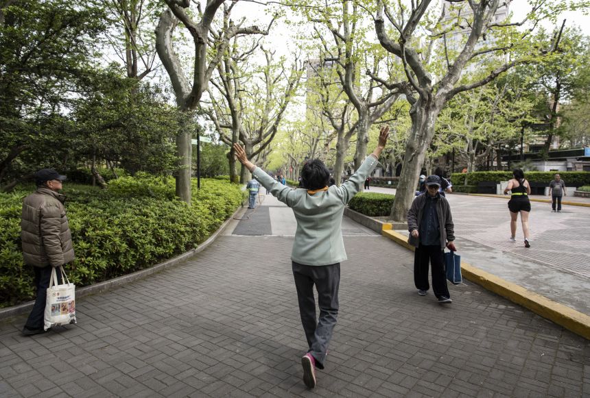 Elderly people walk through a park in Shanghai, China, on April 10, 2021.