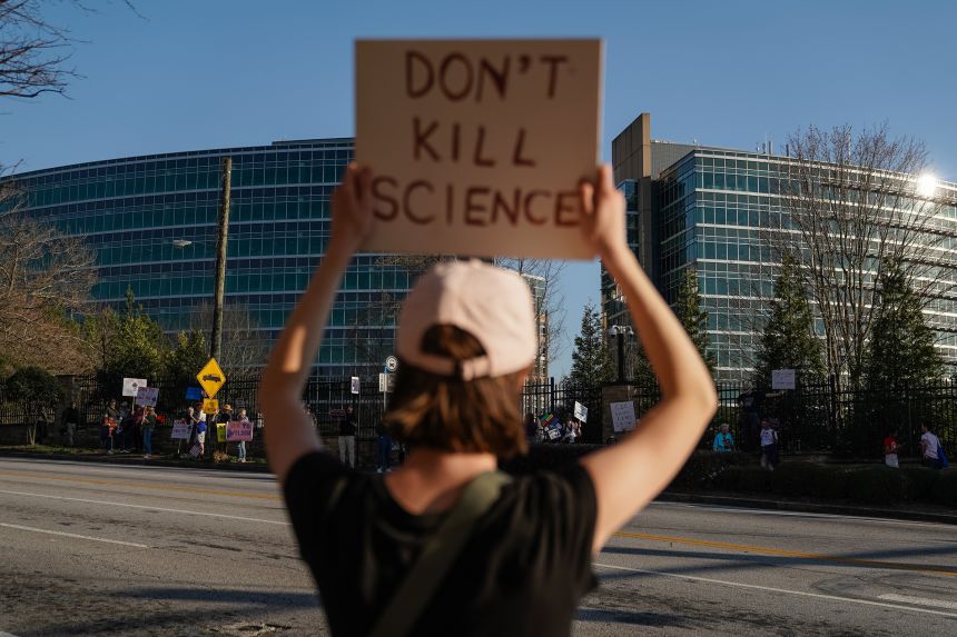 People protest personnel cuts at the US Centers for Disease Control and Prevention in Atlanta on March 12, 2025.