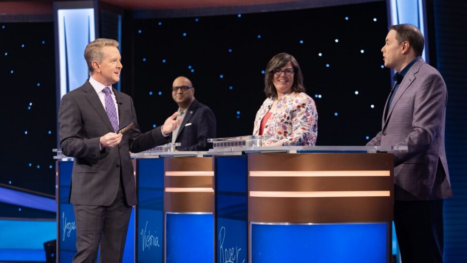 Host Ken Jennings, left, and contestants on "Jeopardy!"