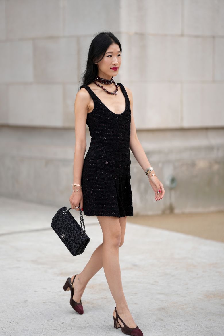 Chinese American influencer Rebecca "Becca" Bloom, attending the Chanel couture show on July 8, 2025. A close-up on her accessories reveals some auspicious stacking.