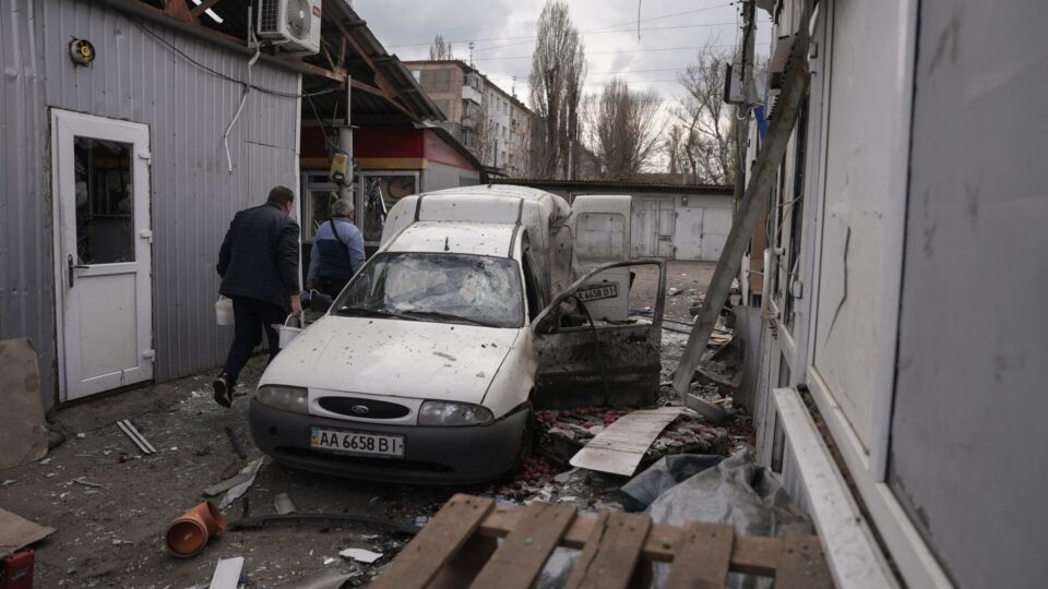 People clear debris at a market hit by a Russian drone strike on April 4, 2026, in Nikopol, Ukraine.