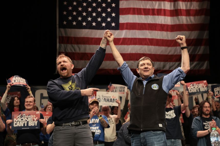 Graham Platner and Troy Jackson stand together during a “Fighting Oligarchy” tour stop at the Collins Center for the Arts on the University of Maine campus on May 24, 2026.