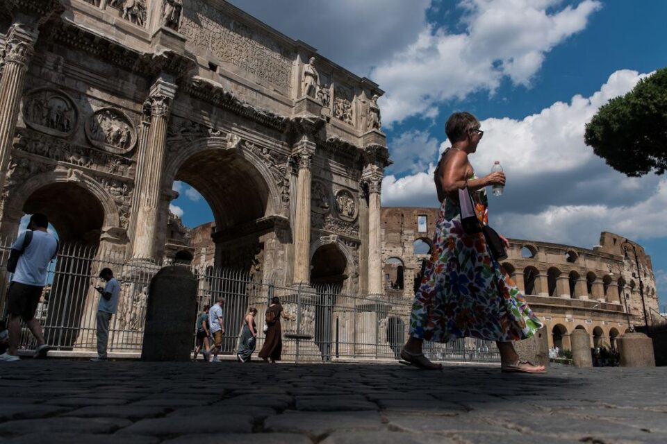 Peole walk by the Colosseum in Rome, Italy, on July 4.