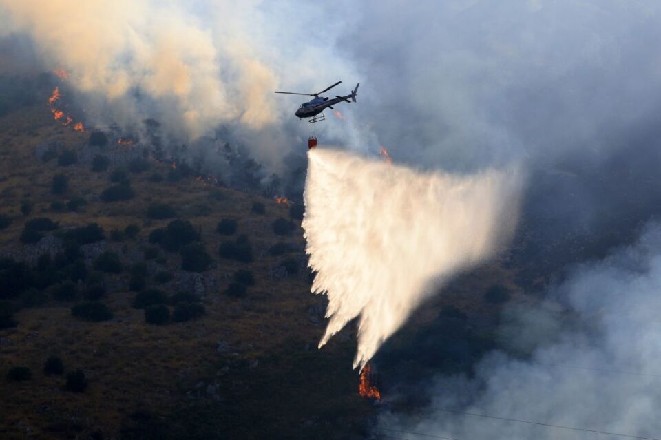 Firefighting aircraft and helicopters try to bring a fire under control on the slopes of Mount Longa near Palermo, Sicily, Italy, on July 15, 2026. Officials in Calabria, a different region north of Sicily, say arsonists there set wildfires using cats with flammable rags tied to their tails.