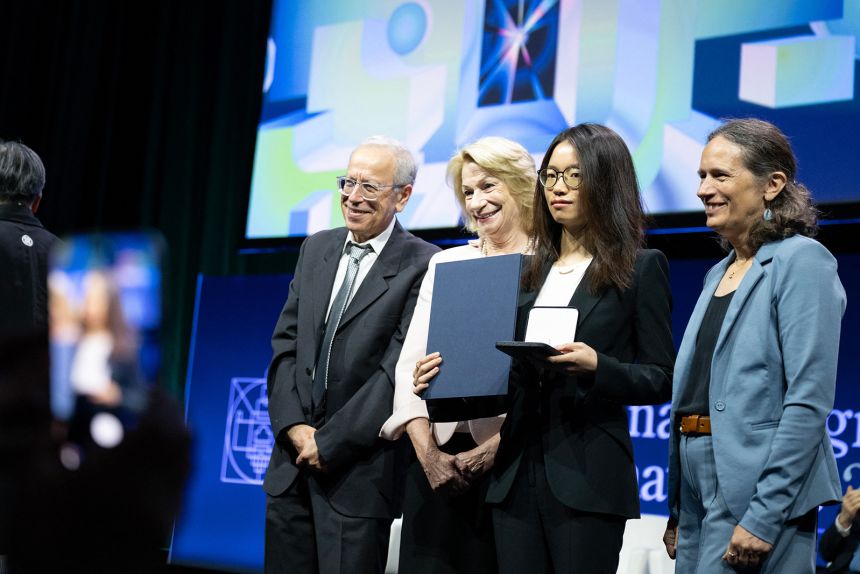 Mathematician Wang Hong, center right, poses for photos after being awarded the 2026 Fields Medal on July 23.