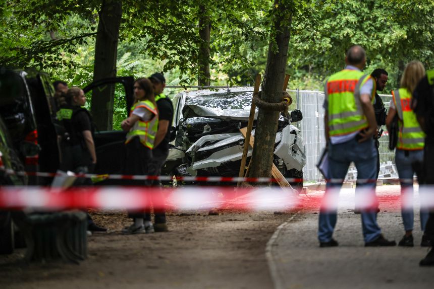 German police stand Sunday near a white van used in an attack Saturday evening on revelers in the Christopher Street Day Berlin pride parade.