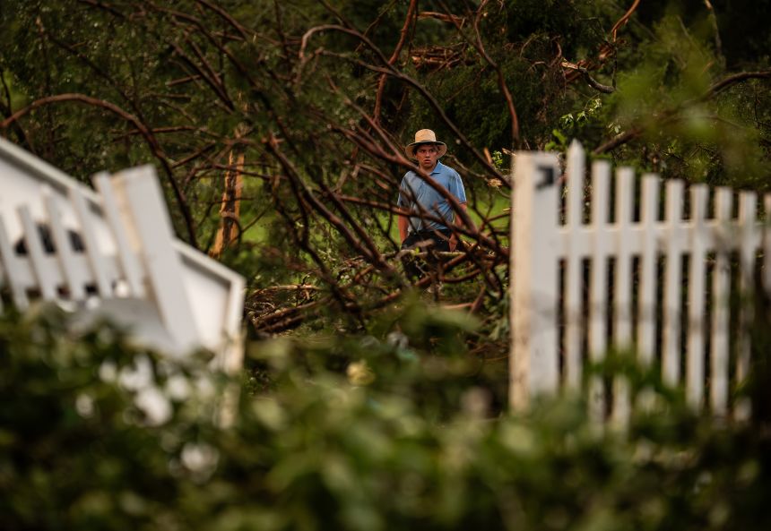 An Amish man surveys storm damage after a tornado moved through Hart County, Kentucky, on Tuesday.